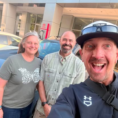 Justin with two smiling customers on pickup day